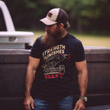 Josh Tyler wearing the Strength Punishes, Cleverness Kills T shirt while standing in front of a truck tail gate.
